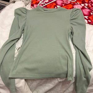 Green blouse with ruffles on shoulders.